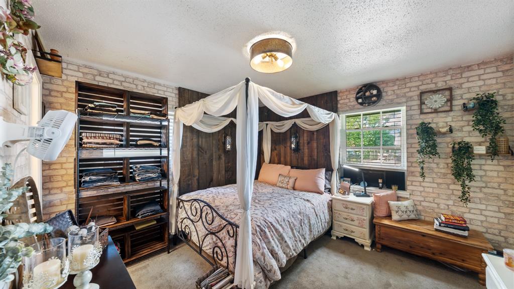 230 Dodson Street Canton, TX 75103 - Photo 10 of 17 a bedroom with a bed and a chandelier