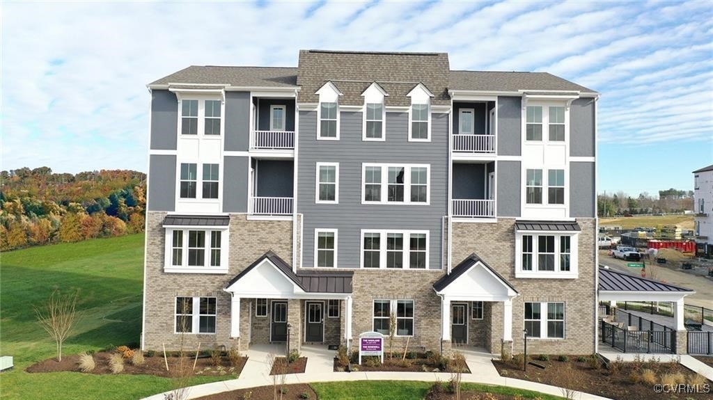 7304 Hancock Towns Lane, Unit A4 Chesterfield, VA 23832 - Photo 1 of 20 a front view of a residential apartment building with a yard