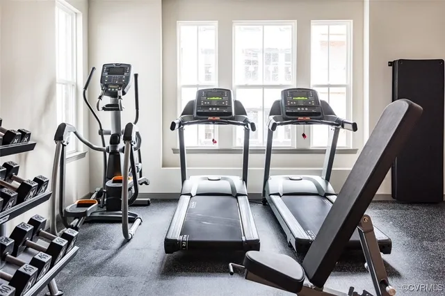 a room with gym equipment and windows