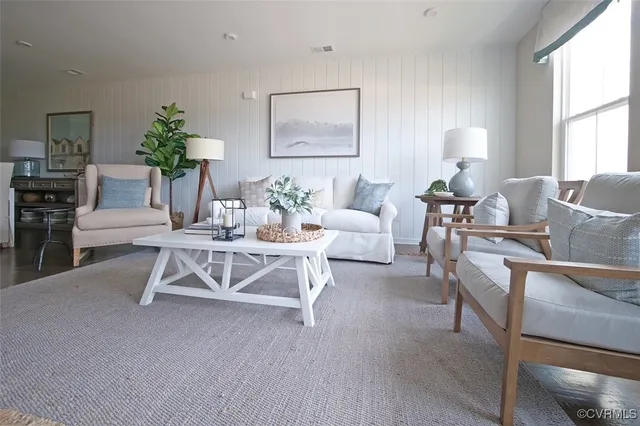a living room with furniture a window and a table