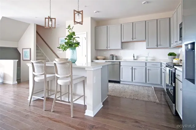 a kitchen with cabinets table and chairs