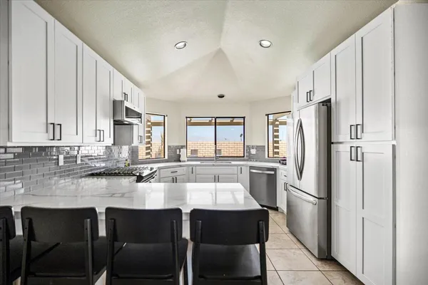 a kitchen with a sink and a large window
