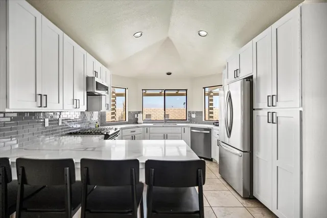 a kitchen with a sink and a large window