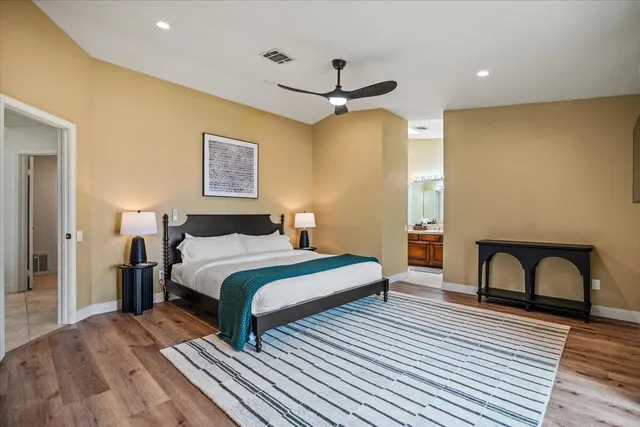 a bedroom with a bed and a large window