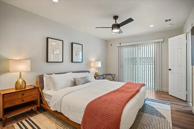 a bedroom with a bed and a flat screen tv