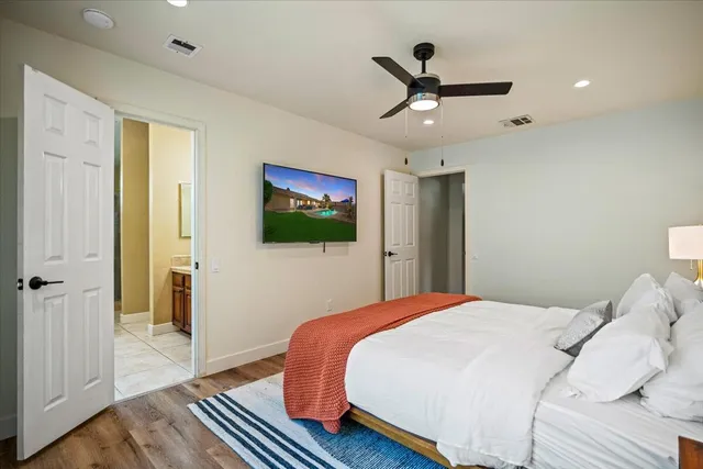 a bed sitting in a bedroom next to a window