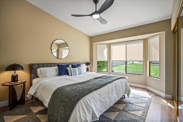 a bathroom with a granite countertop sink toilet a mirror and shower