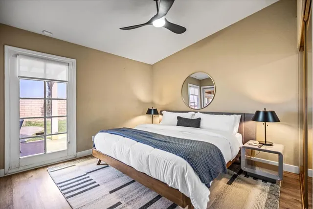 a bedroom with a bed mirror and window