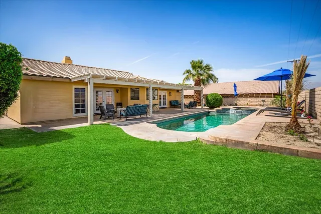 a patio with patio area table and chairs