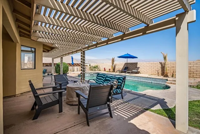 a view of a house with a yard and sitting area