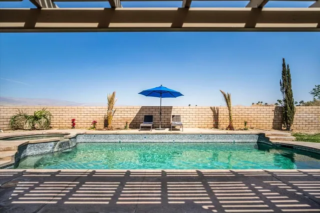 a view of a chairs and table in the balcony