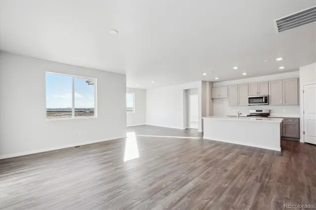 a view of kitchen with wooden floor and window