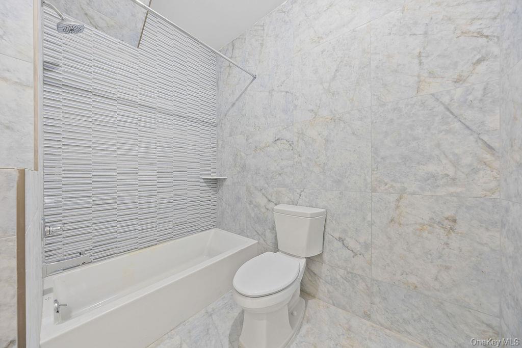 472 West Central Avenue, Unit 105 Spring Valley, NY 10977 - Photo 11 of 22 a bathroom with a toilet and a bathtub
