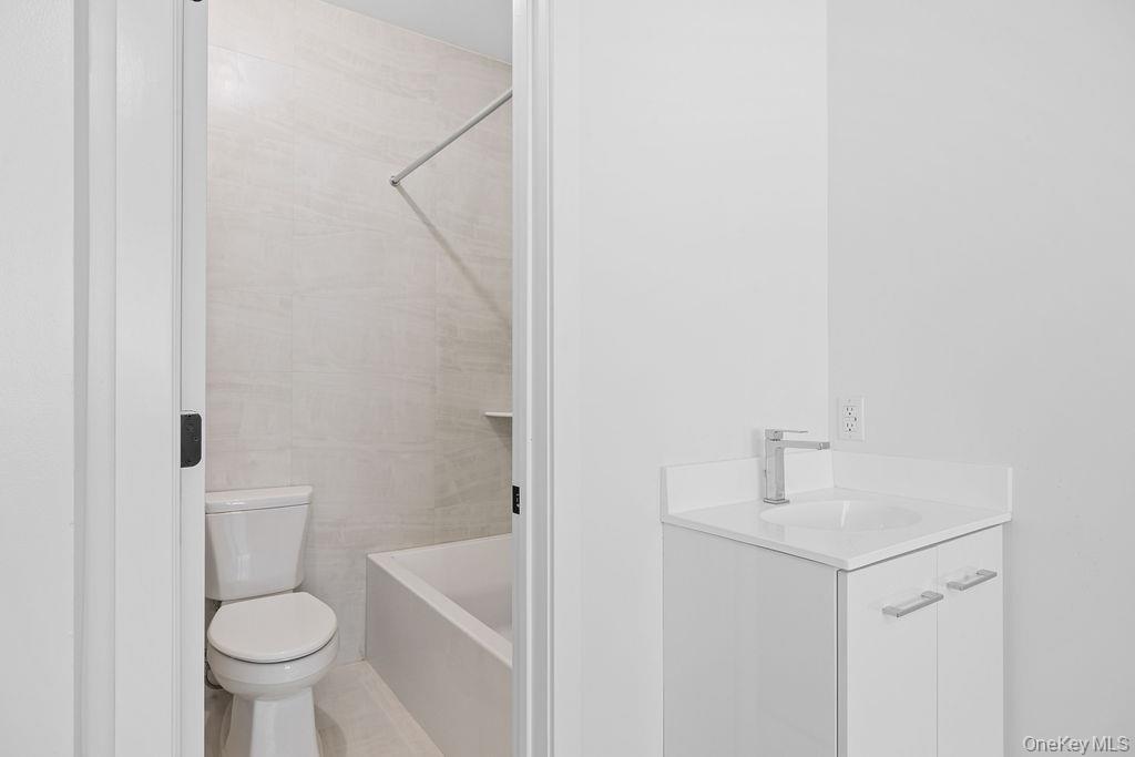 472 West Central Avenue, Unit 105 Spring Valley, NY 10977 - Photo 13 of 22 a white toilet sitting next to a bathroom sink and a toilet