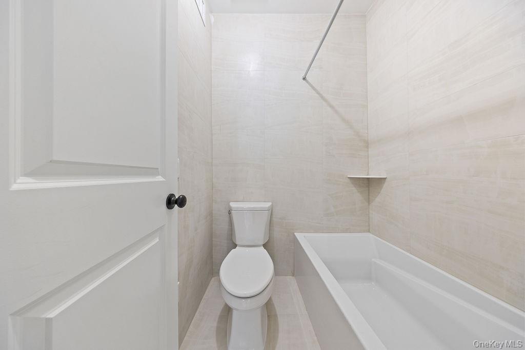 472 West Central Avenue, Unit 105 Spring Valley, NY 10977 - Photo 14 of 22 a bathroom with a toilet and a bathtub