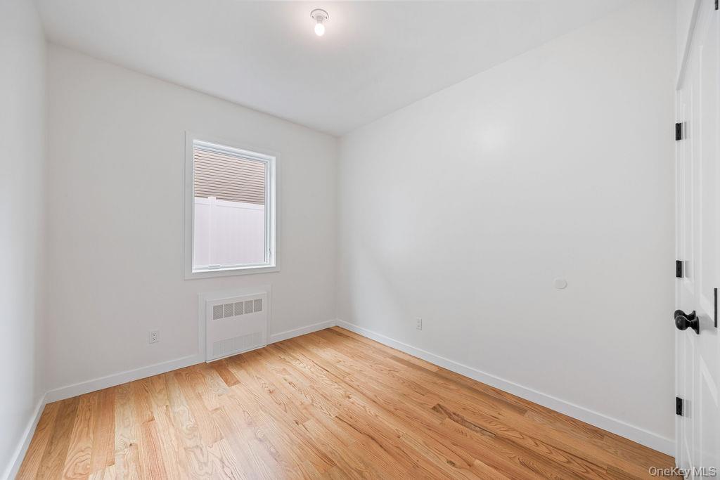 472 West Central Avenue, Unit 105 Spring Valley, NY 10977 - Photo 16 of 22 an empty room with wooden floor and windows