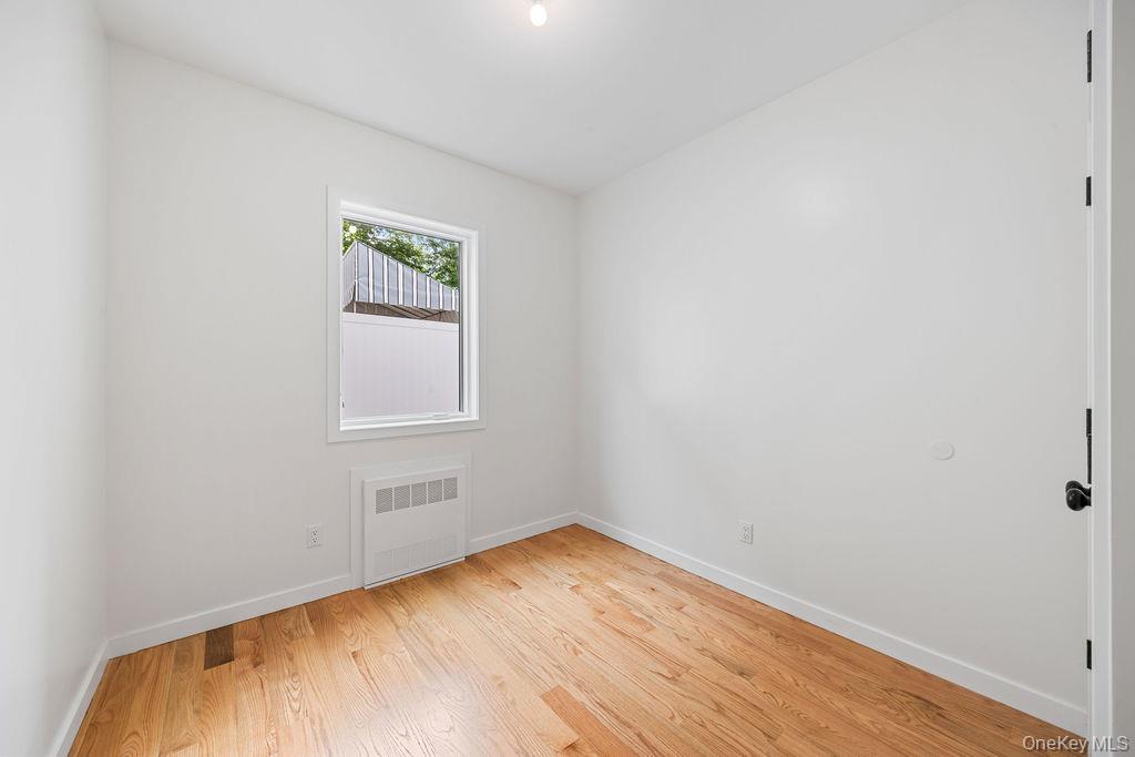 472 West Central Avenue, Unit 105 Spring Valley, NY 10977 - Photo 19 of 22 a view of an empty room with wooden floor and a window