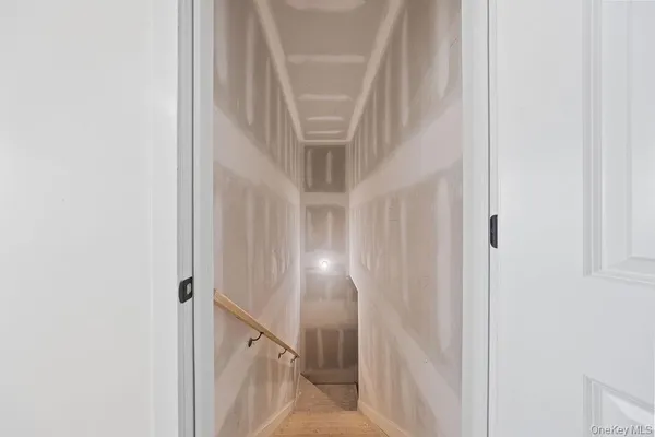 a view of an empty room with glass door and door