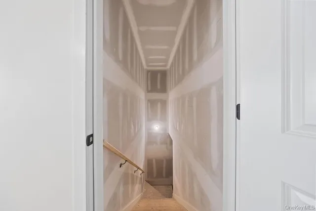 a view of an empty room with glass door and door