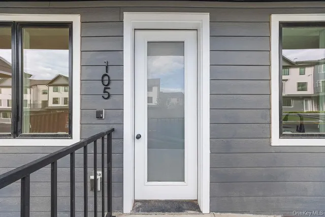 a view of a porch of a house with a door and wooden floor