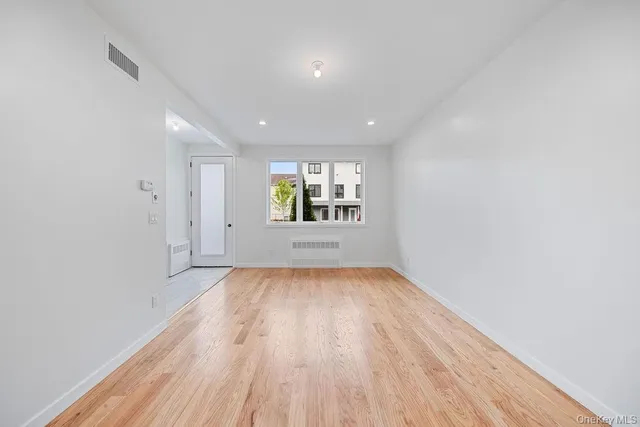 a view of a kitchen with white cabinets