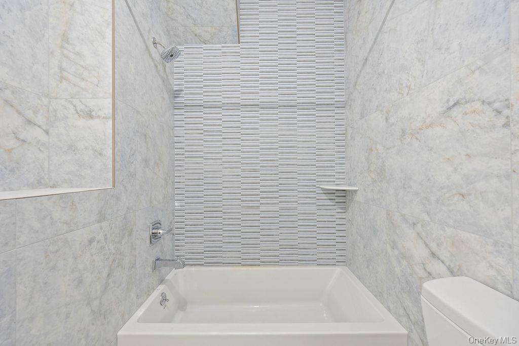 472 West Central Avenue, Unit 105 Spring Valley, NY 10977 - Photo 10 of 22 a bathroom with a bathtub