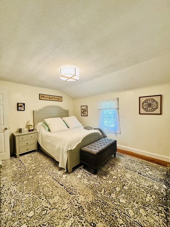 452 Hollis Road Lunenburg, MA 01462 - Photo 17 of 25 a bedroom with a bed and wooden floor