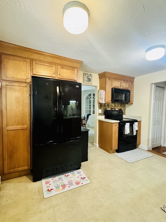 452 Hollis Road Lunenburg, MA 01462 - Photo 20 of 25 a kitchen with granite countertop a refrigerator and a sink