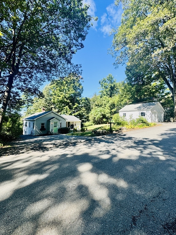 452 Hollis Road Lunenburg, MA 01462 - Photo 2 of 25 a front view of a house with a yard and trees