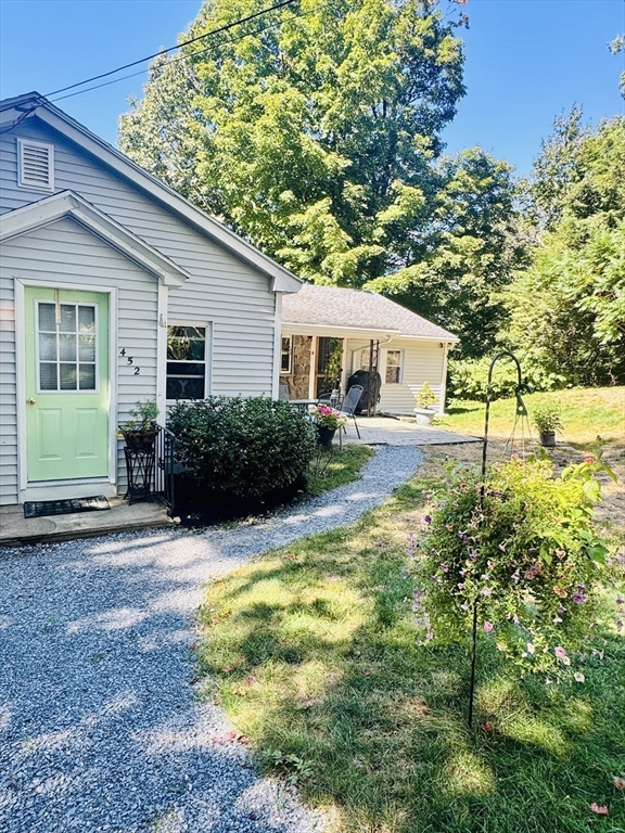 452 Hollis Road Lunenburg, MA 01462 - Photo 7 of 25 a view of a house with a yard and potted plants