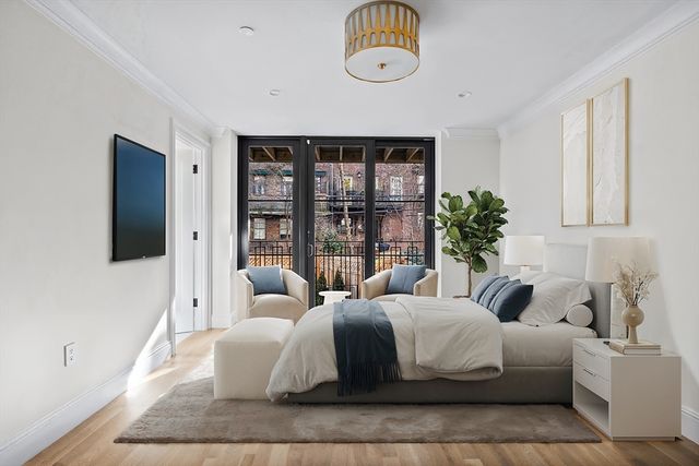 a bedroom with a large bed and a large window