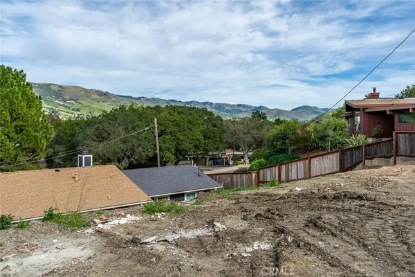 a view of a house with a yard and sitting area