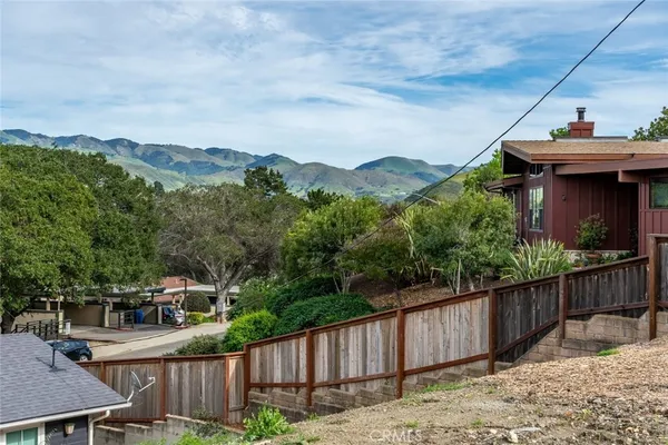 a view of a house with wooden fence