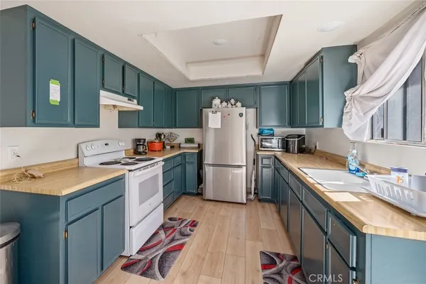 a kitchen with a sink stove and refrigerator