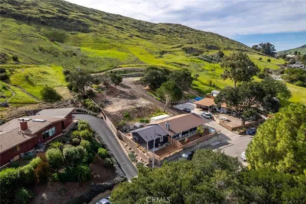 an aerial view of a house with a yard