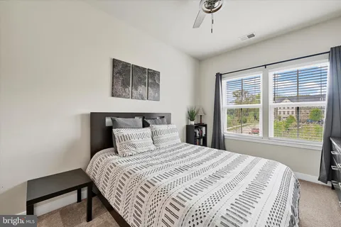 a bedroom with a large bed and a window