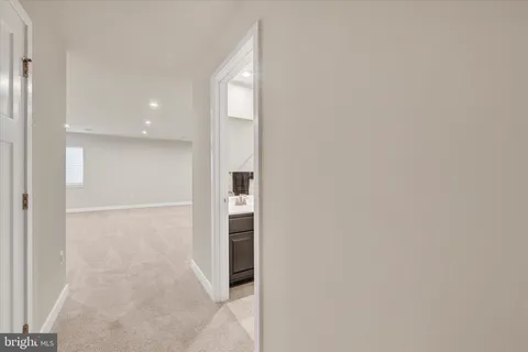 a view of a living room with furniture and a ceiling fan
