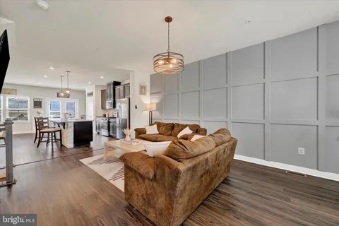 a living room with furniture and kitchen view