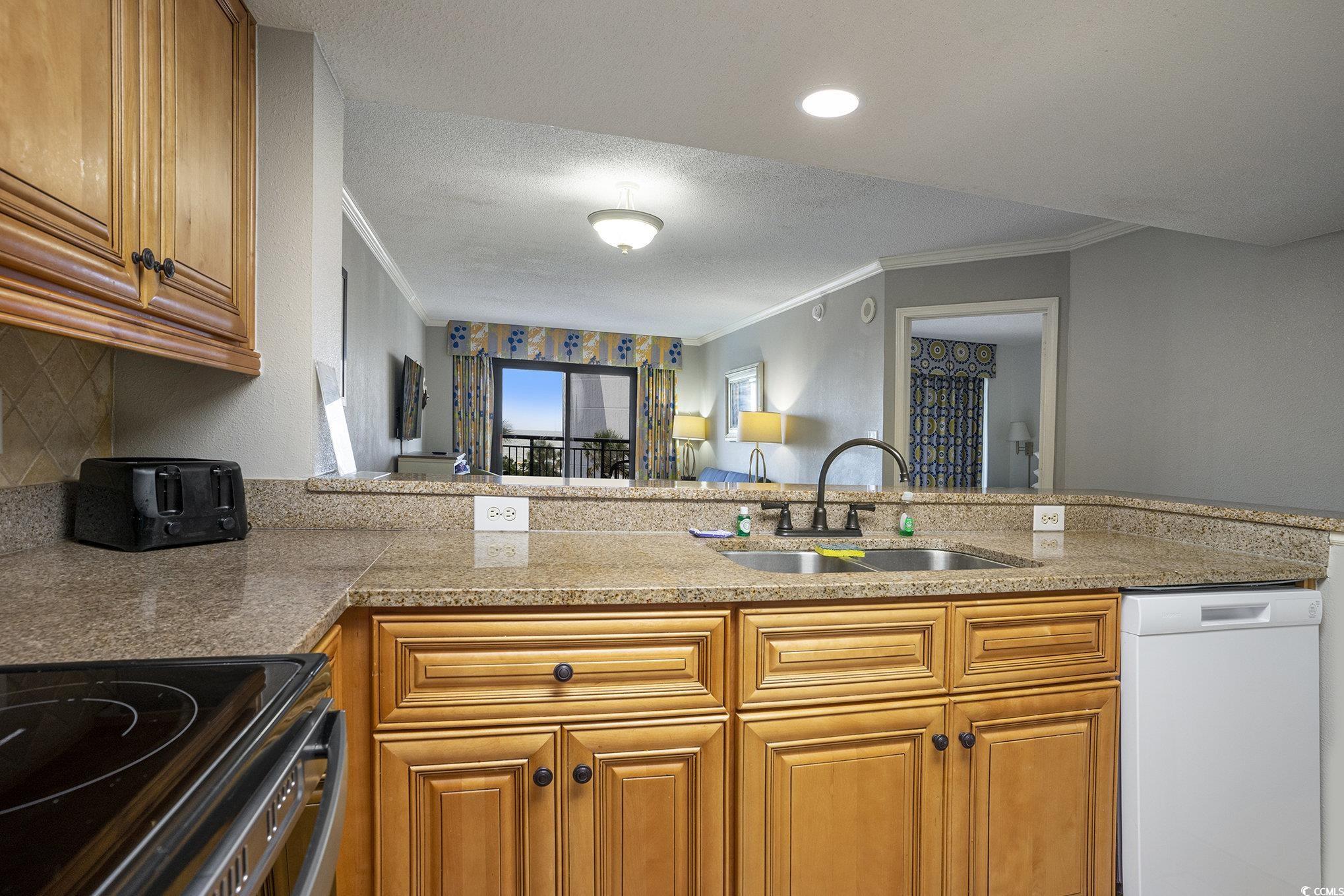 7100 North Ocean Boulevard, Unit 320 Myrtle Beach, SC 29572 - Photo 40 of 40 Kitchen with electric range oven, dishwasher, brown cabinets, a textured ceiling, and open floor plan