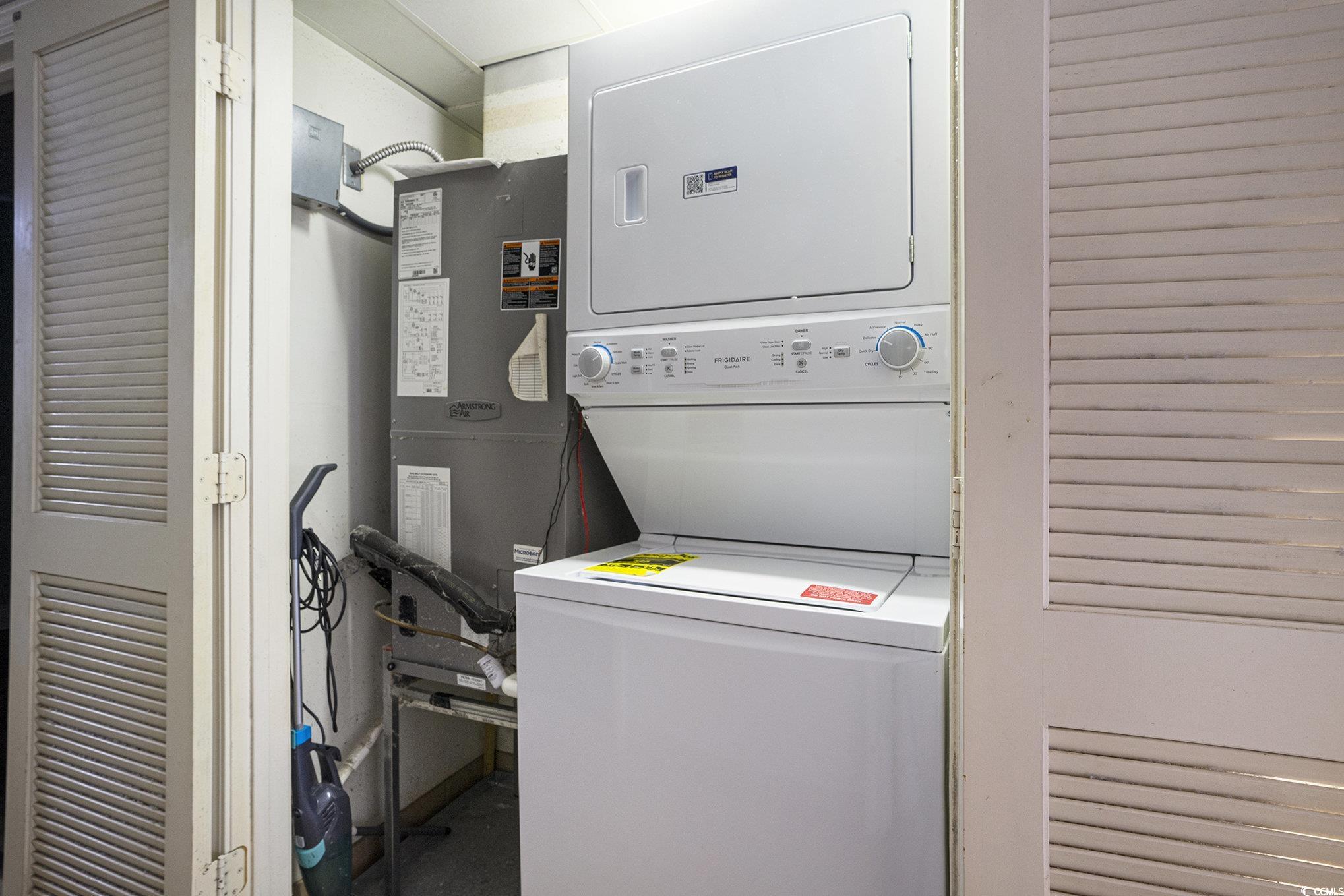 7100 North Ocean Boulevard, Unit 320 Myrtle Beach, SC 29572 - Photo 12 of 40 Laundry room with estacked washer and dryer and heating unit