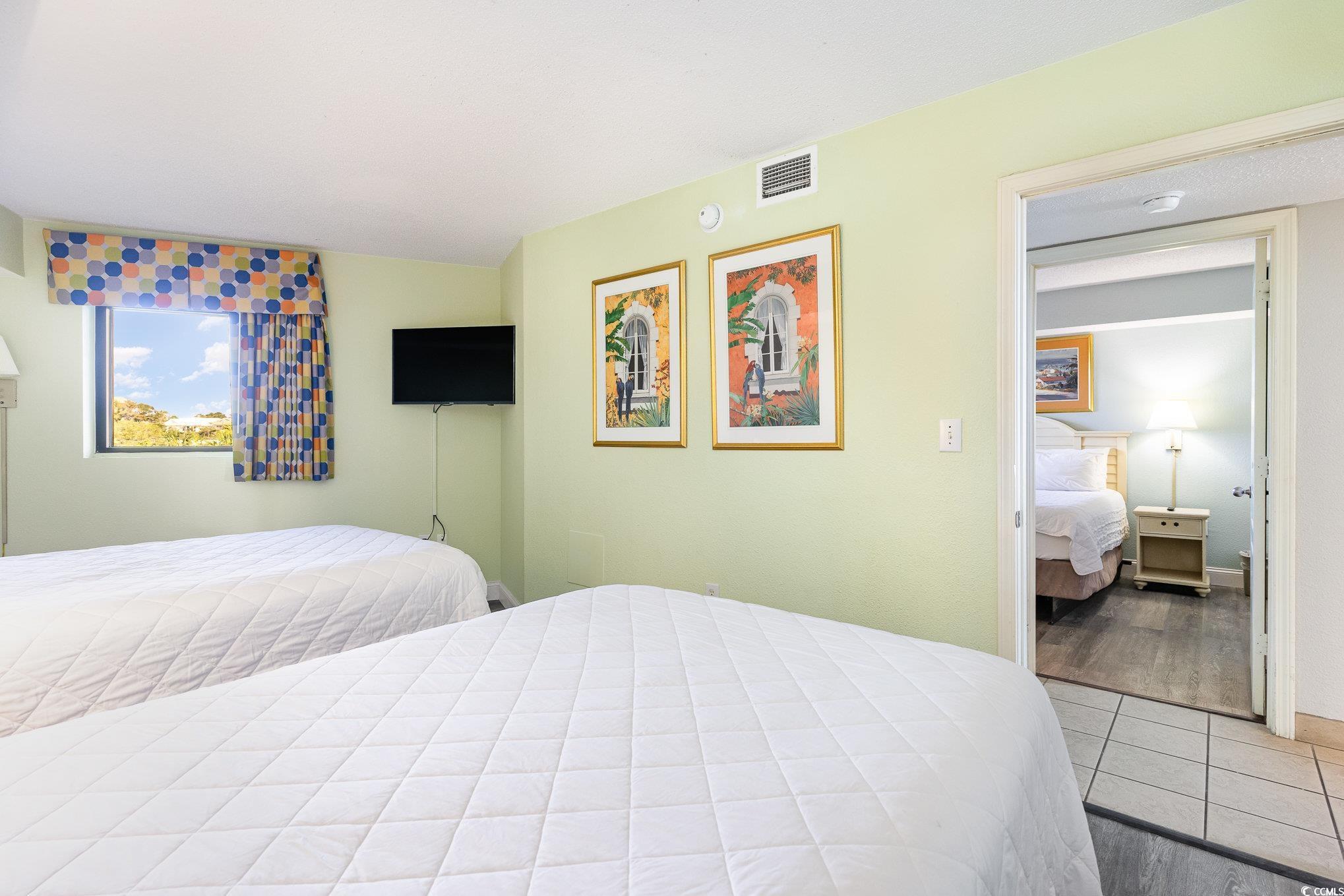 7100 North Ocean Boulevard, Unit 320 Myrtle Beach, SC 29572 - Photo 18 of 40 Bedroom with light tile patterned flooring