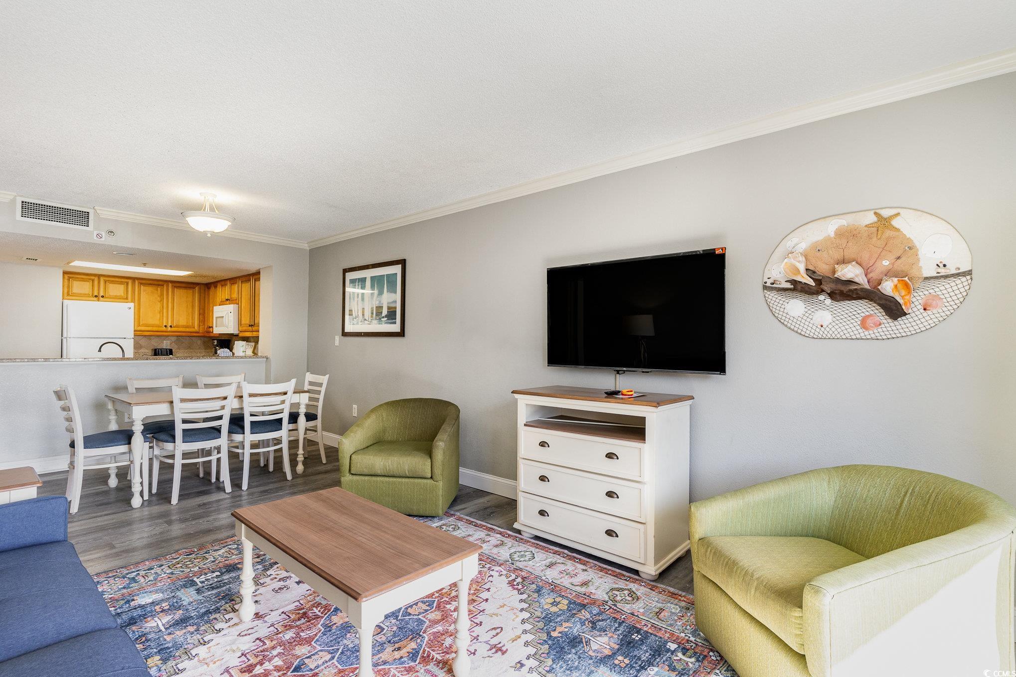 7100 North Ocean Boulevard, Unit 320 Myrtle Beach, SC 29572 - Photo 7 of 40 Living area with ornamental molding, wood finished floors, and baseboards