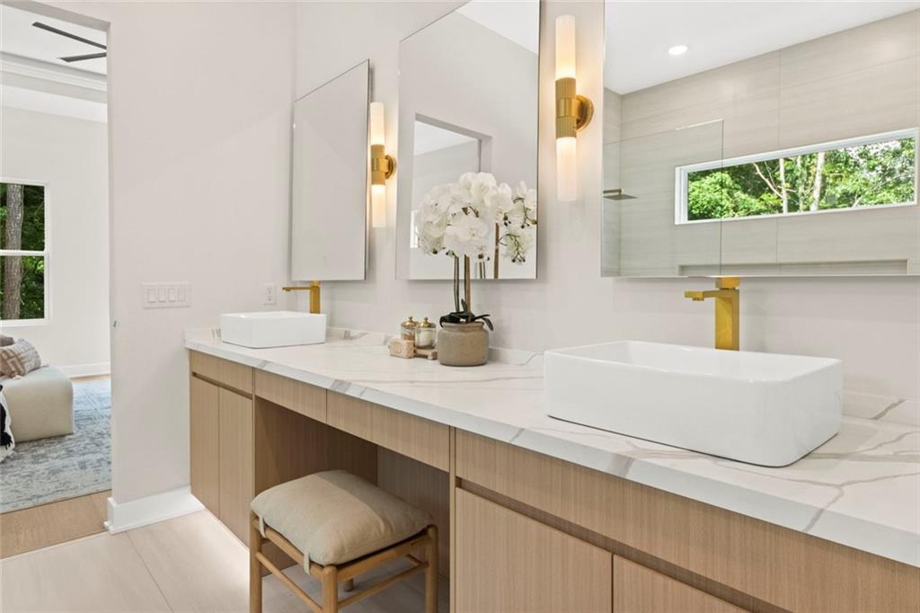 7066 Bells Way Fairburn, GA 30213 - Photo 34 of 64 a bathroom with a sink and a mirror