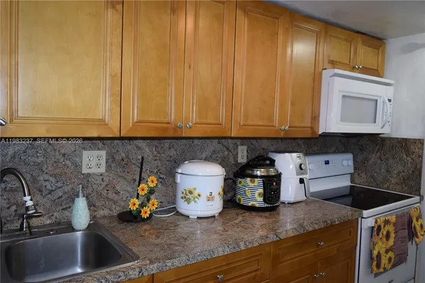 a kitchen with a sink and cabinets