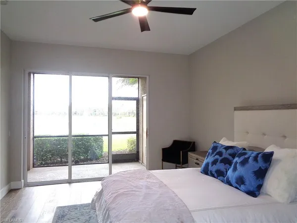 a spacious bedroom with a large bed and a large window