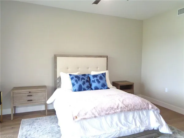 a bedroom with a bed and a night stand