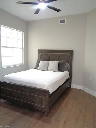 a bed sitting in a bedroom next to a window