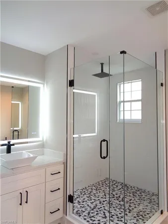 a bathroom with a shower and a sink