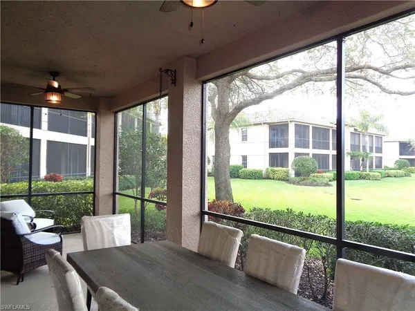 a view of a porch with furniture and garden