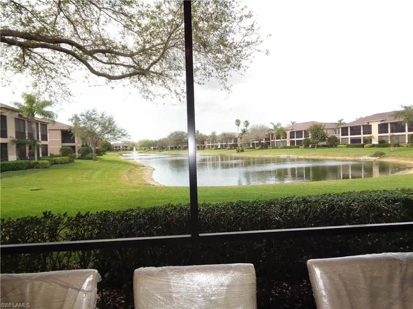 a view of a lake with couches and city view
